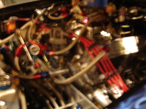 1981 Ford Mustang - Close-up view of an engine bay custom wiring and plumbing.