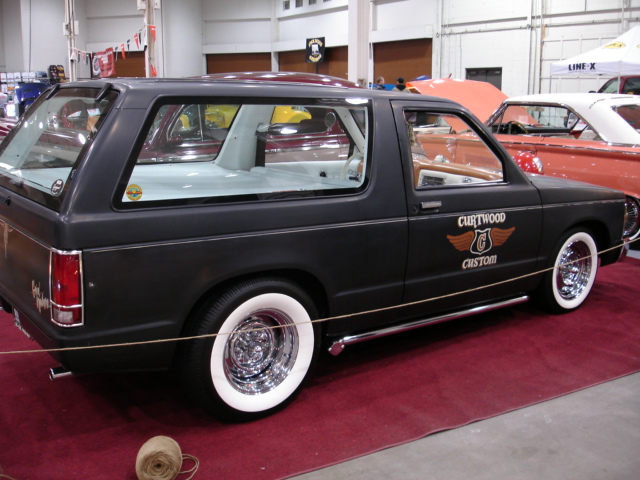 Black SUV with whitewall tires and chrome wheels, side view