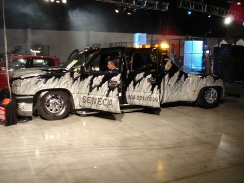 1981 Ford Mustang - A customized pickup truck with unique paintwork and signage is displayed indoors.