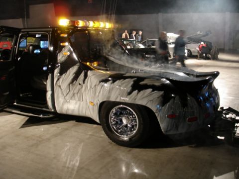 1981 Ford Mustang - A custom tow truck with a distinctive paint scheme and chrome wheels is shown in a dimly lit indoor setting.