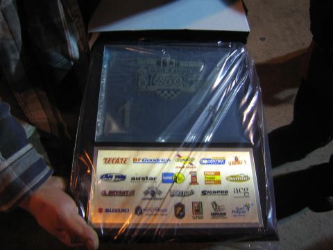 1990 Ford Bronco - photo of a race award plaque with sponsor logos, not a vehicle technical document.