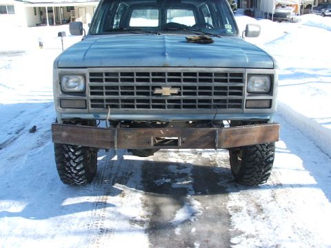 1990 Chevrolet Suburban - This 1990 Chevrolet Suburban features a custom metal bumper and a prominent Chevrolet grille.