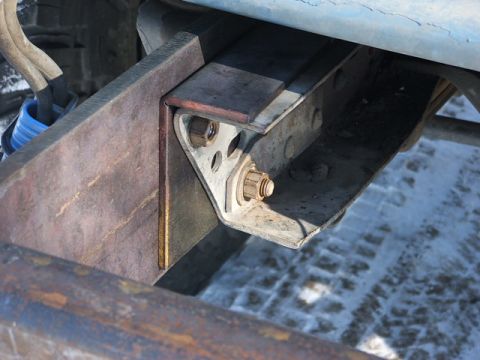 1990 Chevrolet Suburban - Detail of vehicle undercarriage, showing suspension mounting hardware and frame components.