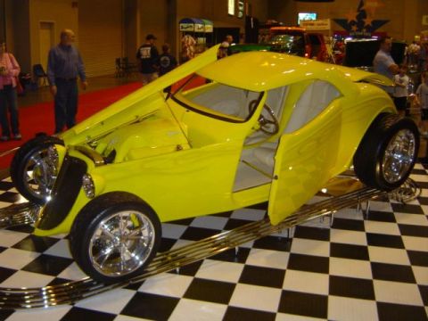 1979 Ford Bronco - A bright yellow custom hot rod is showcased indoors on a checkered floor.