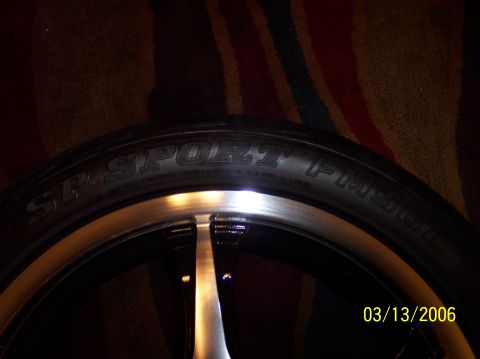 1995 Ford Probe - A close-up view of a tire and rim, with text visible on the tire's sidewall.