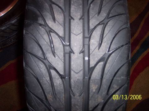 1995 Ford Probe - Close-up of a tire tread shows a directional pattern and a date stamp.
