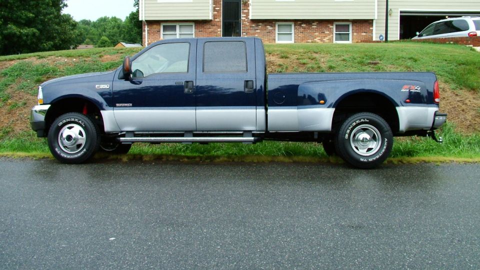 Blue and silver Ford F-350 Super Duty pickup truck, side view. "F350" badge visible