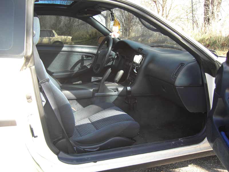 Interior view of a car with cloth seats and dashboard