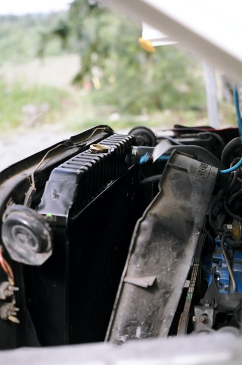 1979 Ford Bronco - Close-up view of a vehicle's radiator and engine bay components.