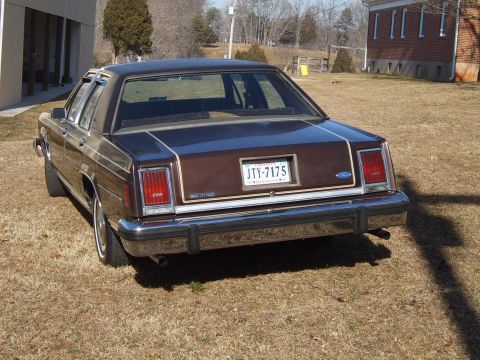 1982 Ford Crown Victoria LTD - Rear view of a brown Ford Crown Victoria sedan parked on dry grass.
