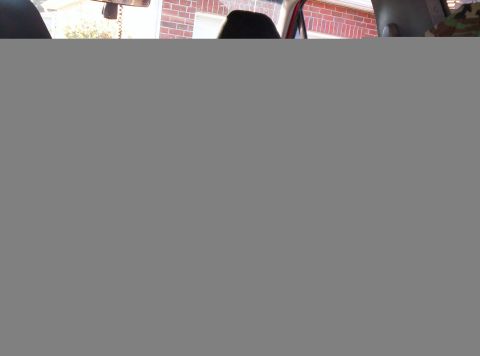 1995 Ford Bronco - Partially corrupted interior photo shot from the back seat of a vehicle; only a narrow strip at the top renders, showing the rearview mirro…