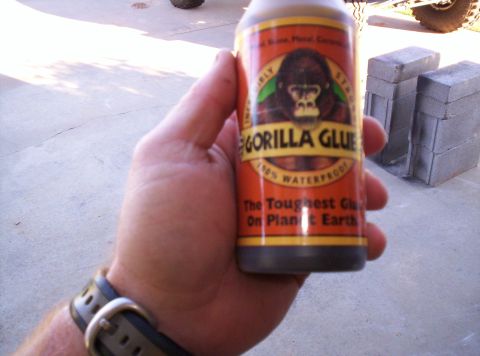 1995 Ford Bronco - A hand holds a bottle of Gorilla Glue, advertising its strength and waterproof qualities.