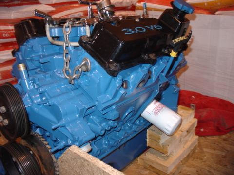 1993 Ford Taurus - A blue Ford 3.0L V6 engine with black valve covers and an oil filter is shown.