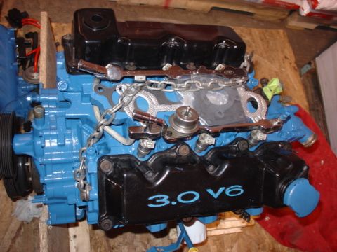 1993 Ford Taurus - A rebuilt 3.0 V6 engine is shown, painted blue with black accents.