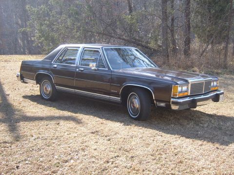 1982 Ford Crown Victoria LTD - This sedan, likely from the early 1980s, is shown from a three-quarter front view on a dry, grassy area.