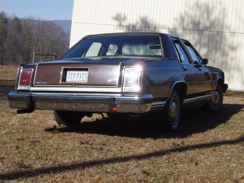 1982 Ford Crown Victoria LTD - Rear view of a brown sedan with a chrome bumper and vertical taillights. The license plate reads JTY-7175.