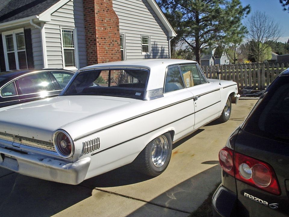 White 1963 Ford Galaxie, rear 3/4 view. Chrome trim and custom wheels