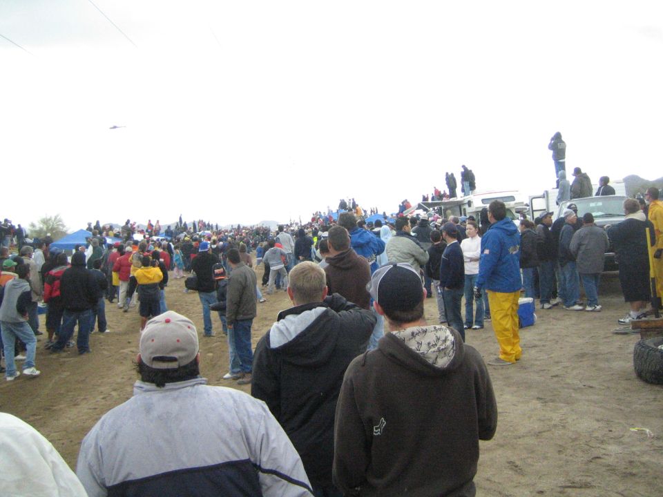 Large crowd of spectators on a dirt course at an off-road desert race