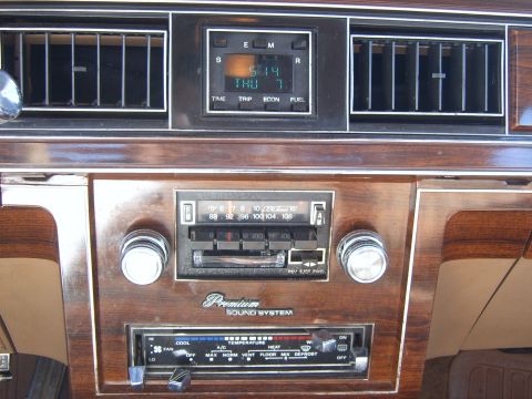 1982 Ford Crown Victoria LTD - Interior view of a 1982 Ford Crown Victoria LTD, its dashboard with a digital clock and premium sound system.