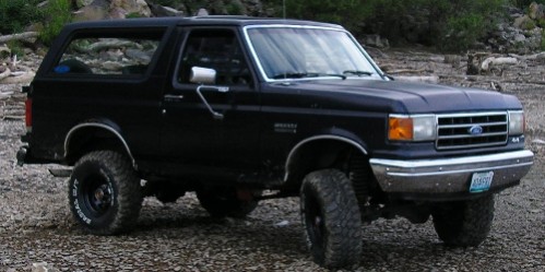 Black 1990 Ford Bronco 3q-front view with lifted suspension