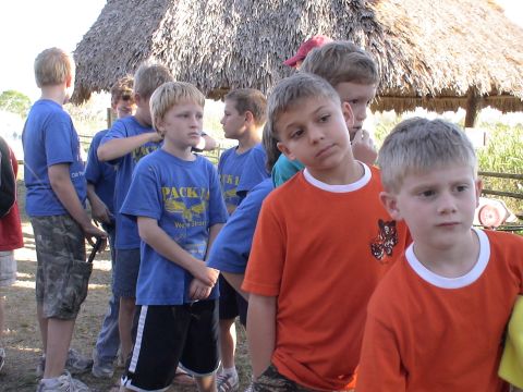 1993 Ford C-350 (Centurion Conversions) - A group of boys stand together outdoors, some wearing blue t-shirts with "PACK 1" visible.