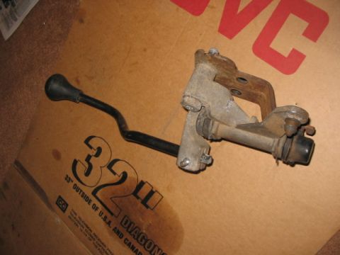 1995 Ford Bronco - Transfer case shifter lever assembly, likely for a 4WD vehicle, shown on a cardboard background with text.