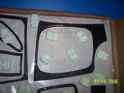 1995 Ford Probe - Carbon fiber dash trim pieces are shown, protected by packing peanuts, with a date stamp of 03/14/2006.