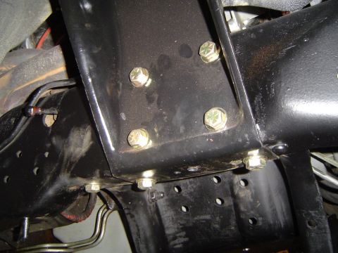1989 Ford Bronco - Detail shot of bolted frame brackets and suspension components, likely during an axle installation.