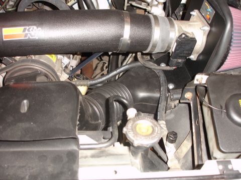 1996 Ford Bronco - Close-up view of the engine's air intake system, a K&N filter and tubing.