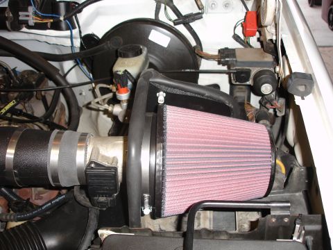 1996 Ford Bronco - Close-up of an engine bay an aftermarket K&N air filter and intake system.