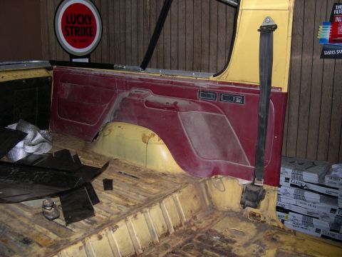 1982 Ford Bronco - Interior view of a vehicle, showing the seatbelt, door panel, and floor.