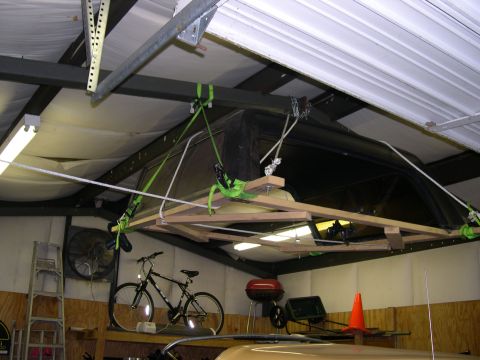 1982 Ford Bronco - A garage scene shows a bicycle, grill, and a large, complexly rigged object hanging from the ceiling.