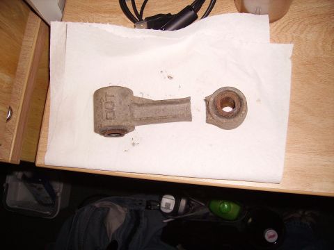 2000 Chevrolet Tahoe - A broken suspension linkage part lies on a paper towel.
