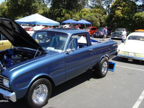 1972 Ford Ranchero - A blue pickup truck is parked at an outdoor event with other vehicles visible.