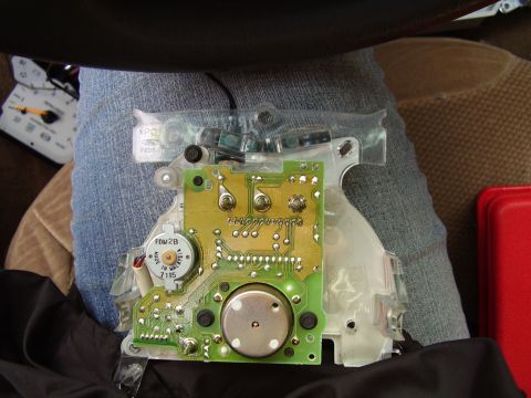 1997 Ford Taurus - This is a close-up view of a vehicle's dashboard circuit board, showing electronic components and a small motor.