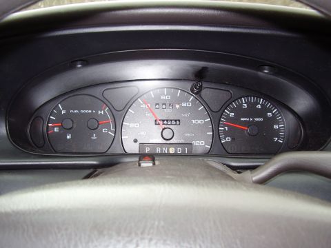 1997 Ford Taurus - The dashboard displays the speedometer, fuel, temperature, and tachometer gauges, along with the odometer reading.
