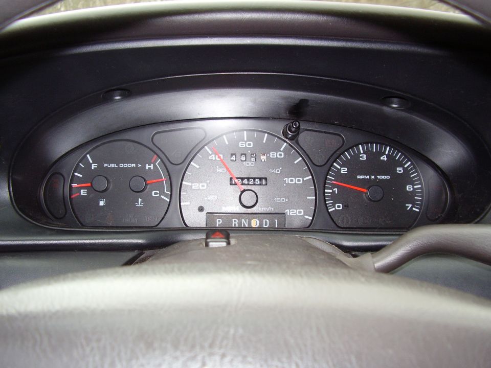 Car dashboard with speedometer, fuel gauge, temp gauge, and RPM gauge. Odometer reads 134251