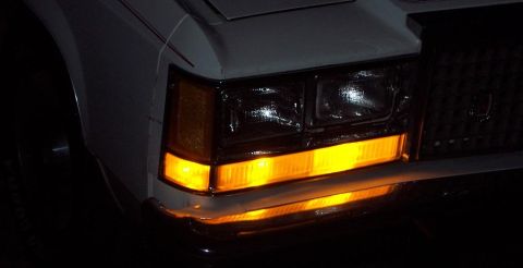 1985 Ford Crown Victoria LTD - Front turn signals of a 1985 Ford Crown Victoria LTD are illuminated, showing the vehicle's distinctive styling.