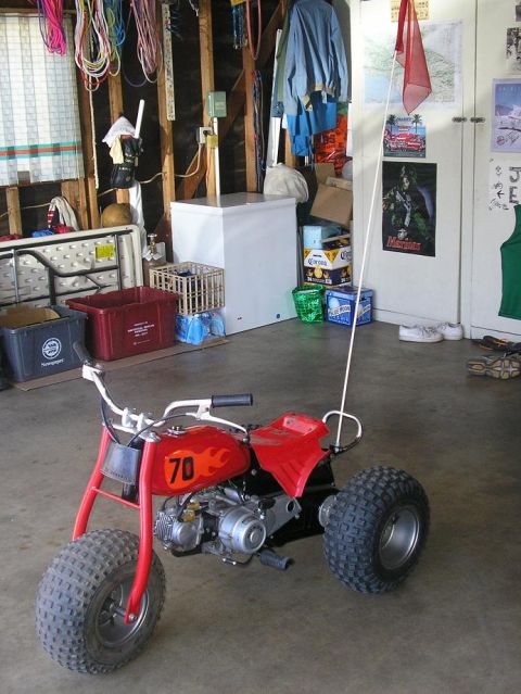 1900 Honda Big Red - This red three-wheeled ATV features flame graphics and the number 70 on its gas tank.
