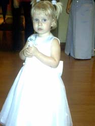 1993 Ford Taurus - A young girl in a white dress stands indoors, with text overlaying the bottom of the image.