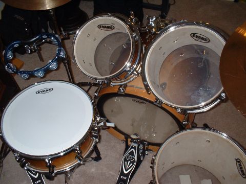 1995 Ford F-150 - A drum kit is set up on a carpeted floor, various drums and cymbals.