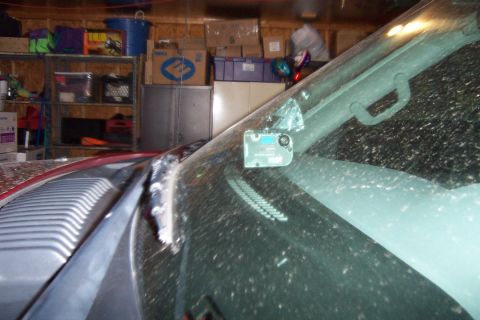 2005 Ford Explorer - Interior view of a vehicle's windshield, showing a small electronic device attached near the rearview mirror.