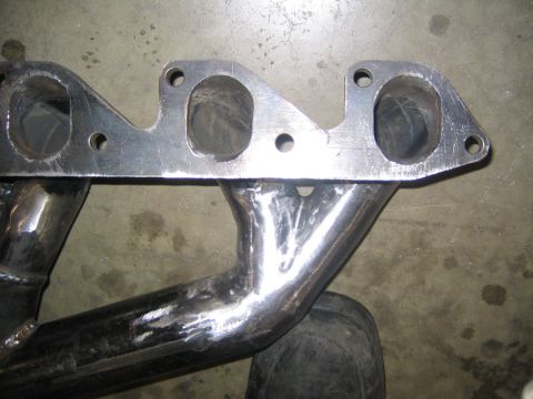1969 Ford Mustang - Close-up of a custom exhaust manifold, likely for an older vehicle.