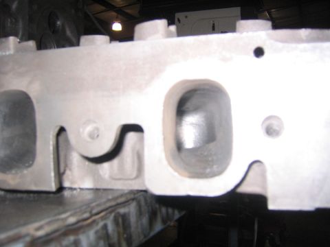 1969 Ford Mustang - Close-up view of an engine cylinder head, showing the ports for intake and exhaust valves.