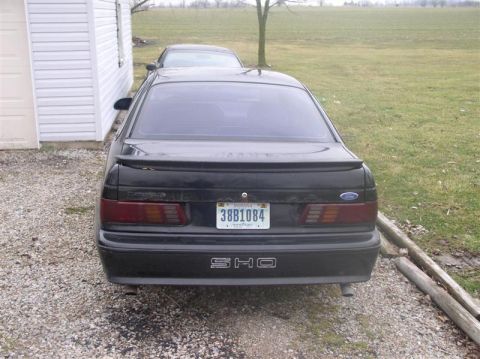 1997 Ford Taurus - Rear view of a black sedan with an "SHO" emblem and Indiana license plate.
