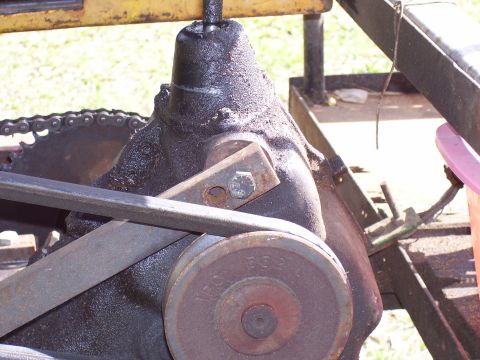 1992 Ford Bronco - A close-up view of a greasy mechanical part, a belt and chain system.