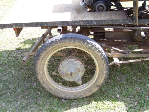 1992 Ford Bronco - A close-up view of the wheel and mechanical components of a custom-built vehicle.