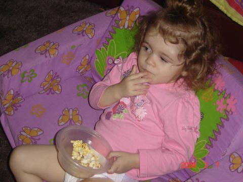 1993 Ford Bronco - Child eating popcorn from a bowl while sitting on a blanket with a butterfly pattern.