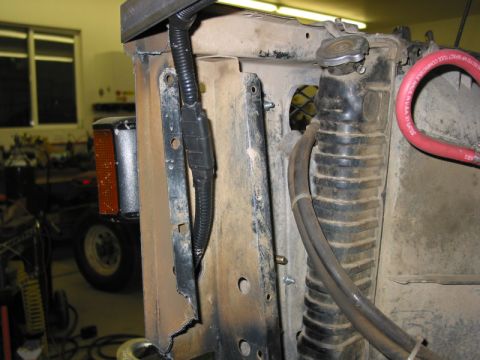 1981 Ford Bronco - Close-up of a vehicle's front end components, including the radiator and part of a turn signal.