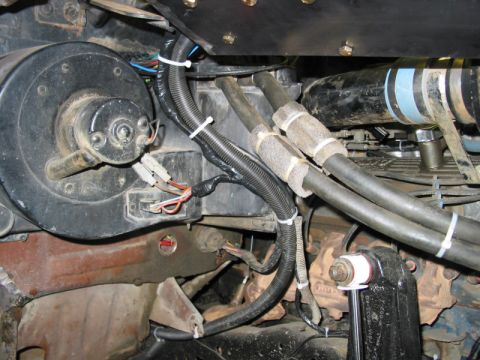 1981 Ford Bronco - Vehicle interior showing blower motor and heater hoses, part of the HVAC system.